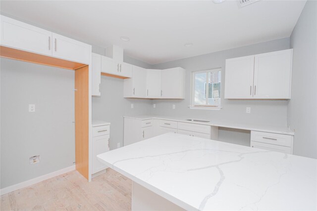 31 Cunard Ave, Staten Island, NY 10304 - kitchen with light stone countertops, white cabinetry, baseboards, and a sink