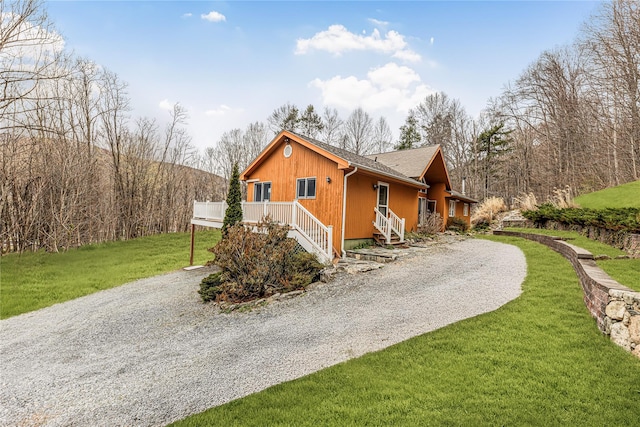 24 Babbling Brook Ln, Cold Spring, NY 10516 - view of side of home featuring gravel driveway, a lawn, a shingled roof, and stairway