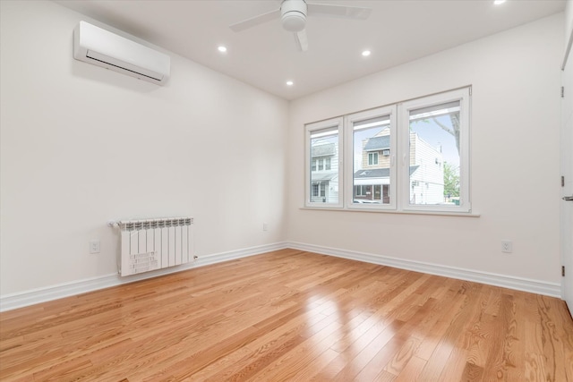 61-13 62nd St, Middle Village, NY 11379 - empty room featuring radiator heating unit, an AC wall unit, light wood-style flooring, a ceiling fan, and baseboards
