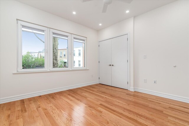 61-13 62nd St, Middle Village, NY 11379 - unfurnished bedroom with light wood-type flooring, baseboards, recessed lighting, a closet, and ceiling fan