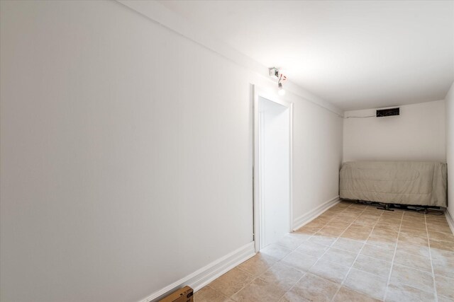 61-13 62nd St, Middle Village, NY 11379 - spare room with baseboards