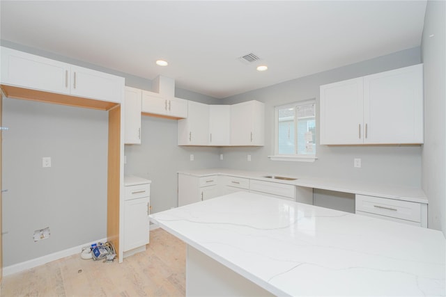 43 Cunard Ave, Staten Island, NY 10304 - kitchen featuring light stone countertops, light wood-type flooring, white cabinets, a sink, and recessed lighting