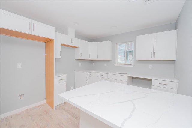 43 Cunard Ave, Staten Island, NY 10304 - kitchen with light stone countertops, white cabinetry, baseboards, and a sink