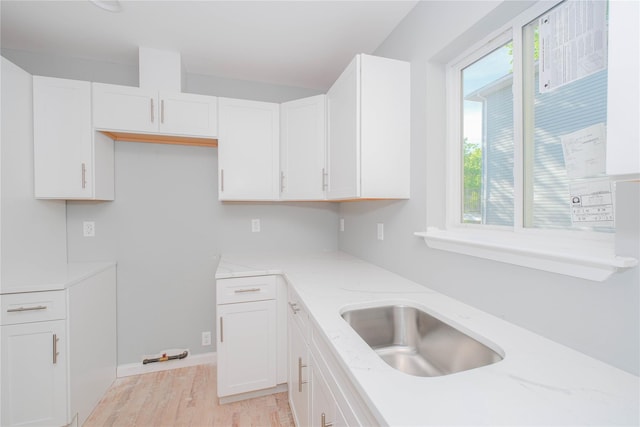 43 Cunard Ave, Staten Island, NY 10304 - kitchen with light stone countertops, white cabinets, light wood-style flooring, and a sink