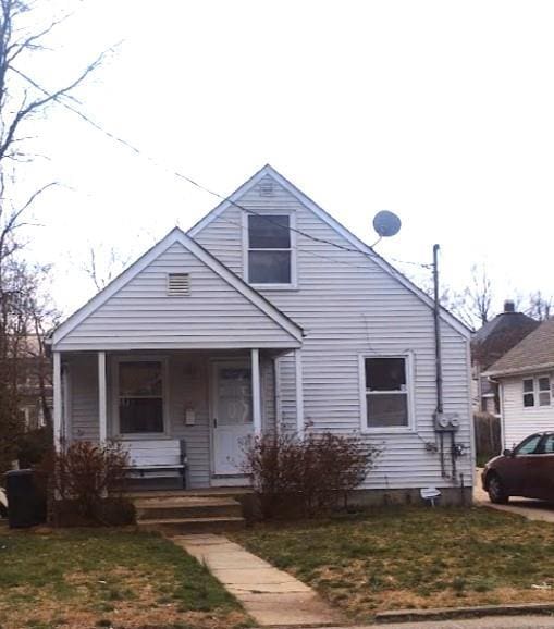 29 Coolidge Ave, Amityville, NY 11701 - bungalow-style home with a porch and a front yard