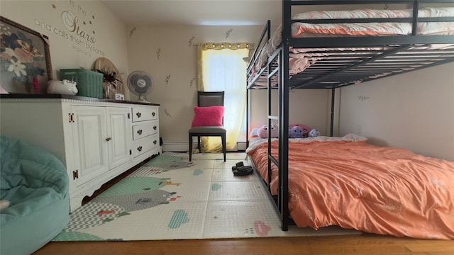 25 Center Ave, Bay Shore, NY 11706 - bedroom featuring wood finished floors and a baseboard heating unit