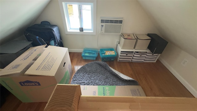 25 Center Ave, Bay Shore, NY 11706 - bonus room with wood finished floors, baseboards, a wall mounted AC, and lofted ceiling