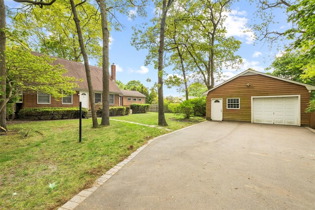 60 Hagerman Ave, East Patchogue, NY 11772 - view of property exterior featuring a chimney, driveway, a garage, and an outdoor structure