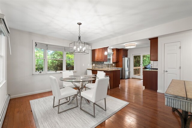 60 Hagerman Ave, East Patchogue, NY 11772 - dining room with a baseboard heating unit, a chandelier, hardwood / wood-style floors, and baseboards