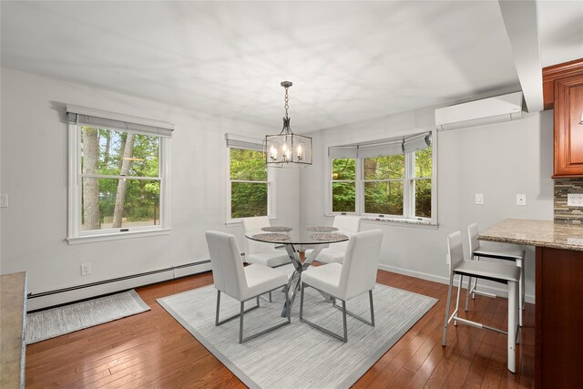 60 Hagerman Ave, East Patchogue, NY 11772 - dining area featuring a wall mounted AC, a baseboard heating unit, a chandelier, and dark wood-style flooring