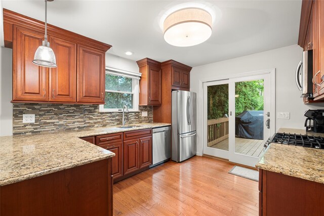 60 Hagerman Ave, East Patchogue, NY 11772 - kitchen with stainless steel appliances, a sink, light stone counters, light wood-style flooring, and recessed lighting