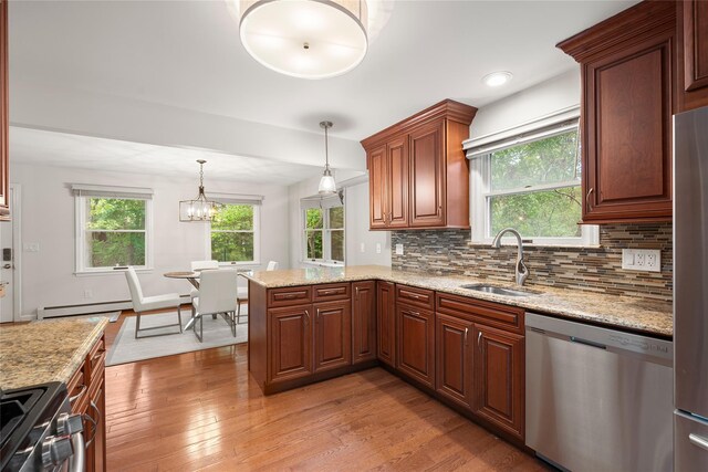 60 Hagerman Ave, East Patchogue, NY 11772 - kitchen featuring appliances with stainless steel finishes, a sink, light wood-style flooring, baseboard heating, and decorative backsplash