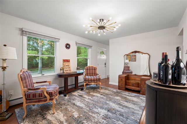 60 Hagerman Ave, East Patchogue, NY 11772 - sitting room featuring wood finished floors, a chandelier, baseboard heating, and baseboards