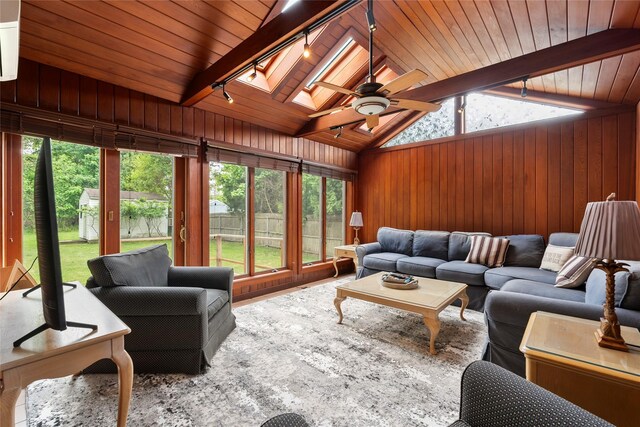 60 Hagerman Ave, East Patchogue, NY 11772 - living room with a skylight, wooden walls, wood ceiling, ceiling fan, and track lighting