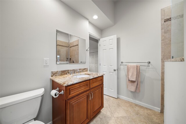 60 Hagerman Ave, East Patchogue, NY 11772 - bathroom featuring vanity, toilet, tile patterned flooring, a tile shower, and baseboards