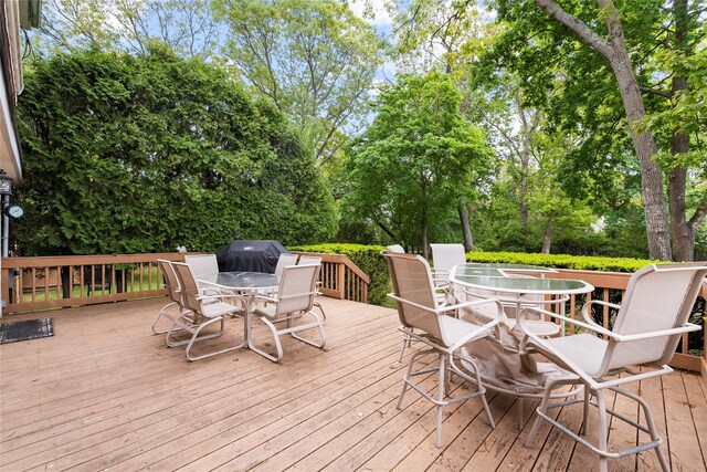 60 Hagerman Ave, East Patchogue, NY 11772 - wooden terrace featuring outdoor dining area, view of scattered trees, and a grill