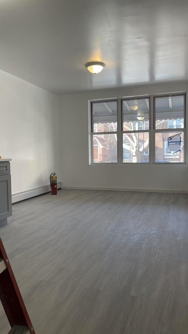 1505 E 29th St, Brooklyn, NY 11229 - empty room featuring wood finished floors, plenty of natural light, and baseboards