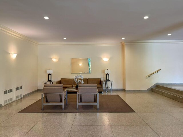 lobby with ornamental molding, recessed lighting, and stairs