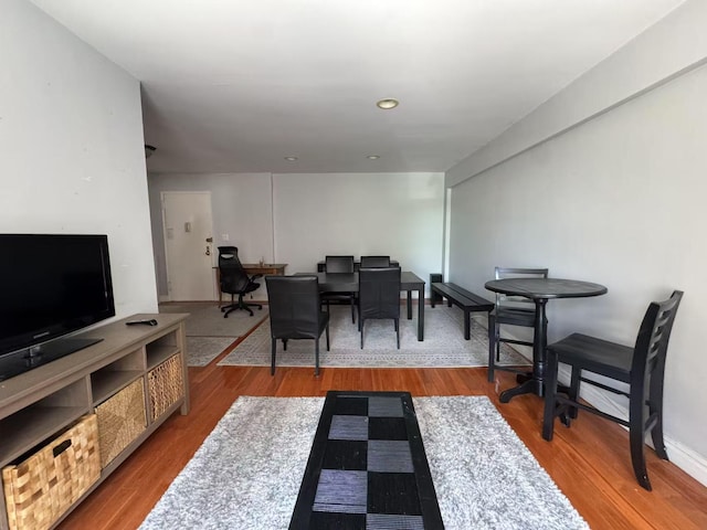 living area featuring wood finished floors, an office area, and recessed lighting