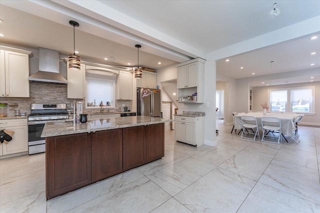 1064 Highland Pl, Woodmere, NY 11598 - kitchen with wall chimney exhaust hood, appliances with stainless steel finishes, decorative backsplash, a sink, and recessed lighting