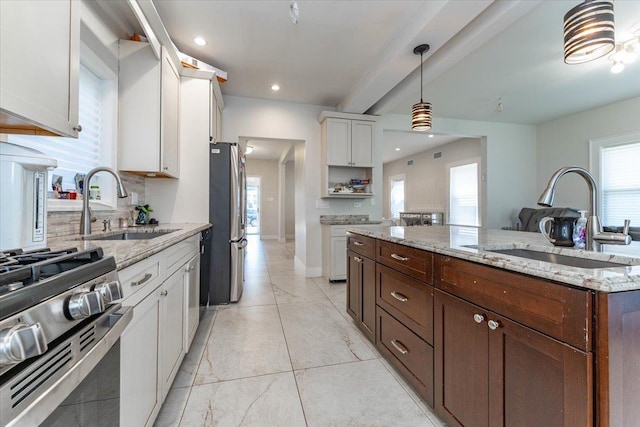 1064 Highland Pl, Woodmere, NY 11598 - kitchen with a sink, stainless steel appliances, white cabinetry, decorative light fixtures, and recessed lighting