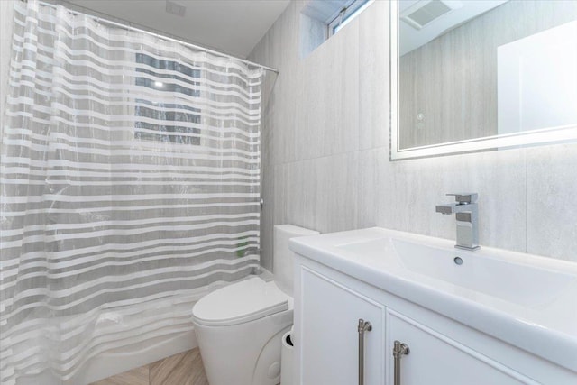 1064 Highland Pl, Woodmere, NY 11598 - full bathroom with toilet, vanity, a shower with shower curtain, and tile walls