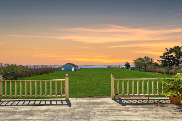 46 Tuthill Point Rd, East Moriches, NY 11940 - wooden deck featuring a water view, a lawn, and an outdoor structure