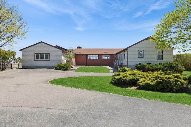 46 Tuthill Point Rd, East Moriches, NY 11940 - ranch-style house with driveway and a chimney