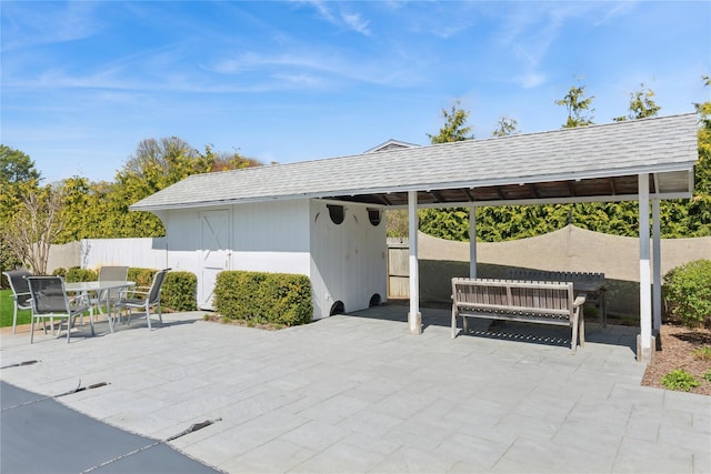 46 Tuthill Point Rd, East Moriches, NY 11940 - view of patio with fence, outdoor dining space, and an outbuilding