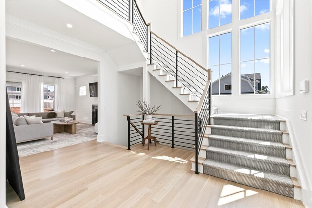 50 Depot Rd, Westhampton Beach, NY 11978 - stairway featuring wood finished floors, a large fireplace, and recessed lighting