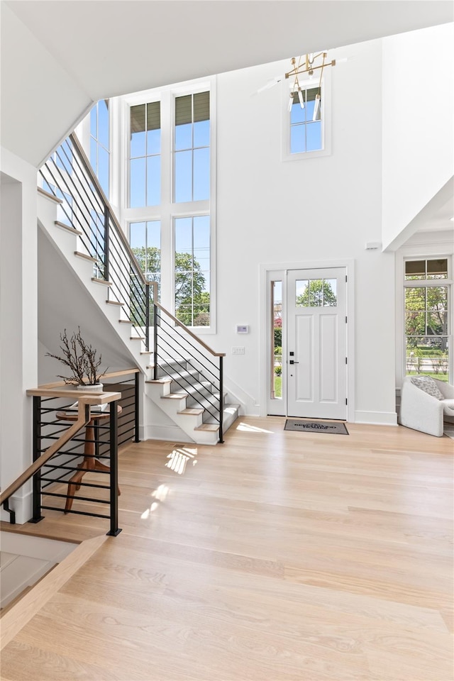 50 Depot Rd, Westhampton Beach, NY 11978 - foyer featuring a high ceiling, stairs, wood finished floors, and baseboards