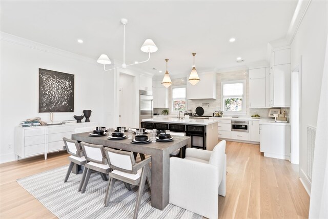 50 Depot Rd, Westhampton Beach, NY 11978 - dining room featuring light wood-style flooring, ornamental molding, and recessed lighting