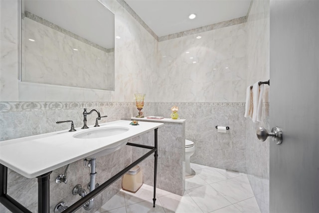 270-10 Grand Central Pkwy Unit 11V, Floral Park, NY 11005 - bathroom featuring tile walls, a sink, and toilet
