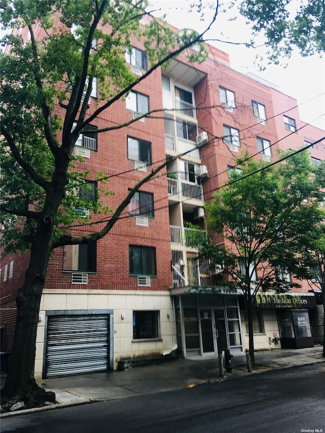 view of apartment building / complex featuring an attached garage