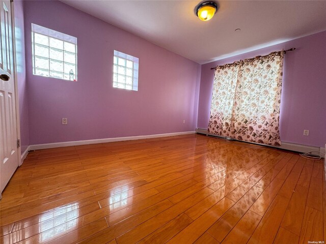 unfurnished room featuring light wood-style flooring and baseboards