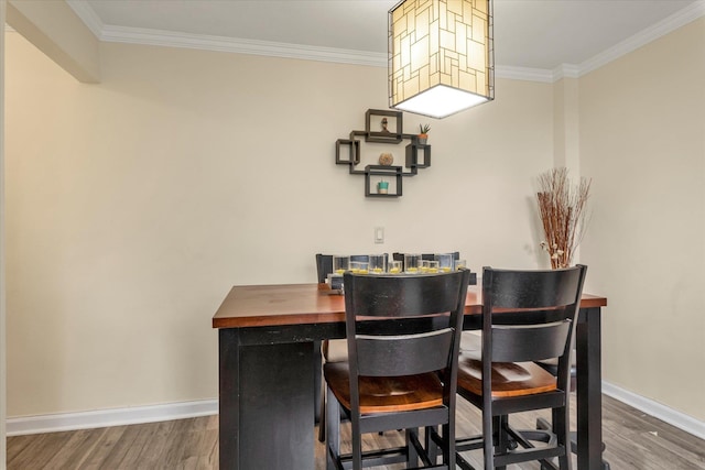 150-10 71st Ave Unit 6H, Kew Garden Hills, NY 11367 - dining space featuring wood finished floors, ornamental molding, and baseboards