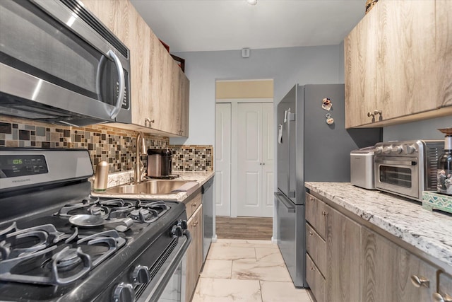 150-10 71st Ave Unit 6H, Kew Garden Hills, NY 11367 - kitchen featuring stainless steel appliances, a sink, light marble finish flooring, backsplash, and light stone counters