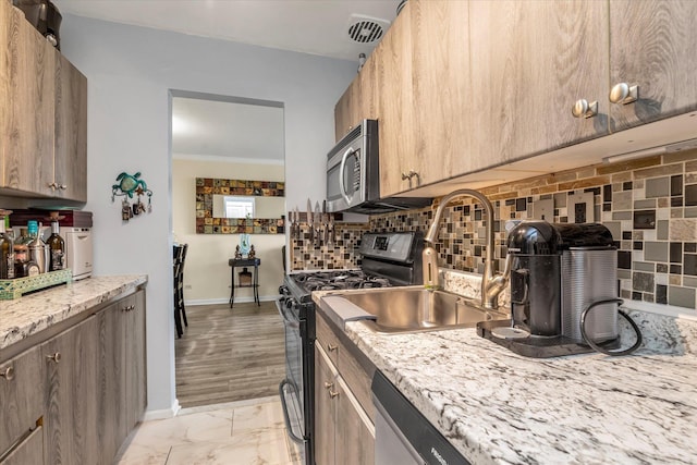 150-10 71st Ave Unit 6H, Kew Garden Hills, NY 11367 - kitchen featuring appliances with stainless steel finishes, tasteful backsplash, light marble finish floors, a sink, and baseboards