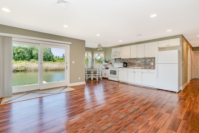 2874 Shore Rd, Seaford, NY 11783 - unfurnished living room with wood finished floors, recessed lighting, baseboards, a ceiling fan, and a water view