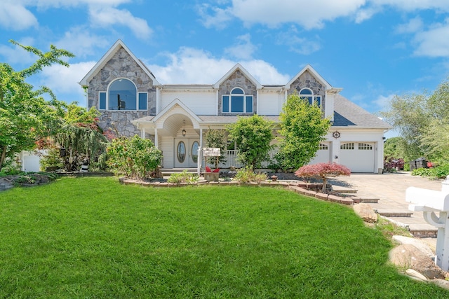 2874 Shore Rd, Seaford, NY 11783 - view of front of house featuring concrete driveway, a front lawn, and stone siding