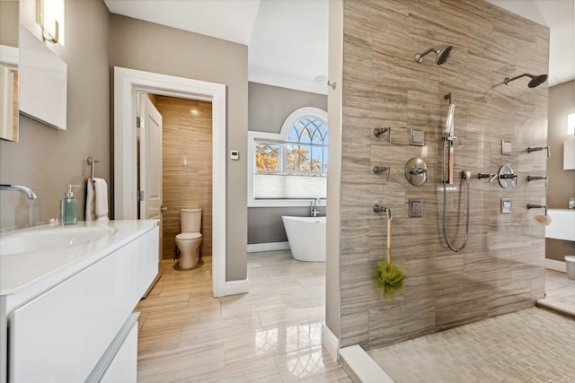 4 Warton Pl, Garden City, NY 11530 - bathroom featuring a tile shower, a freestanding bath, vanity, toilet, and baseboards