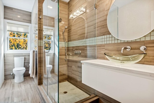 4 Warton Pl, Garden City, NY 11530 - bathroom featuring toilet, tile walls, a tile shower, and vanity