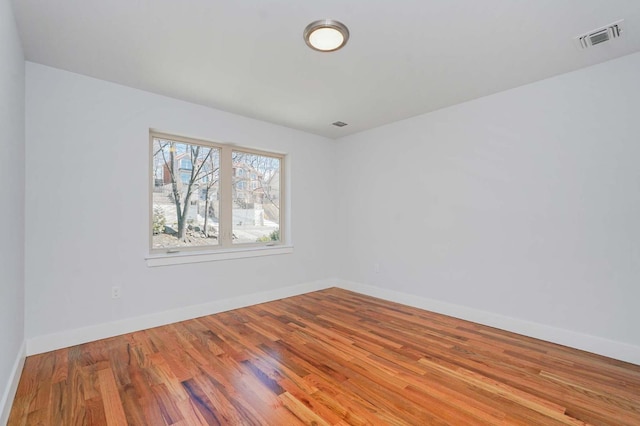 unfurnished room featuring wood finished floors and baseboards