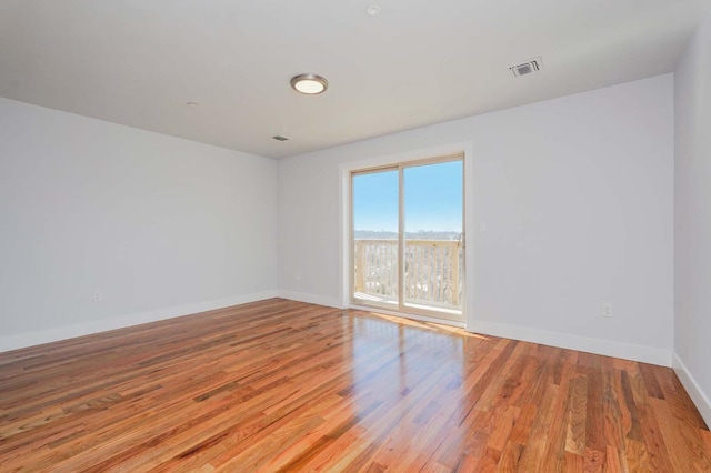 empty room with wood finished floors and baseboards