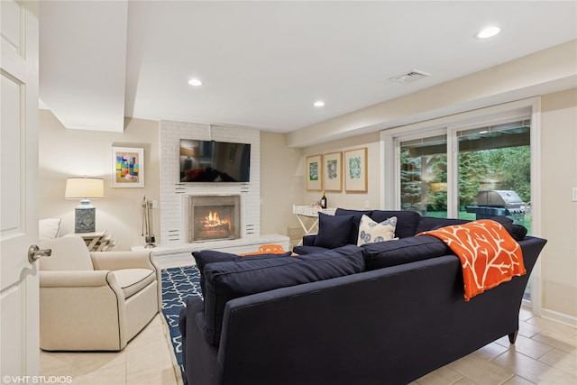 475 Lilac Ln, Cutchogue, NY 11935 - living room featuring light tile patterned floors, a brick fireplace, and recessed lighting