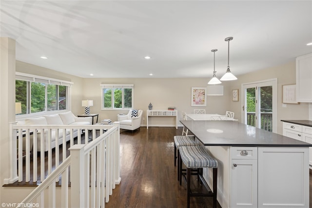 475 Lilac Ln, Cutchogue, NY 11935 - kitchen with dark countertops, plenty of natural light, white cabinetry, dark wood-style flooring, and recessed lighting