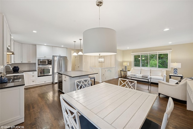 475 Lilac Ln, Cutchogue, NY 11935 - dining space with dark wood finished floors, recessed lighting, and beverage cooler