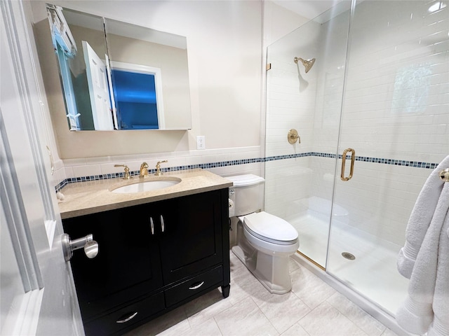 475 Lilac Ln, Cutchogue, NY 11935 - bathroom featuring a stall shower, vanity, tile walls, tile patterned flooring, and a wainscoted wall