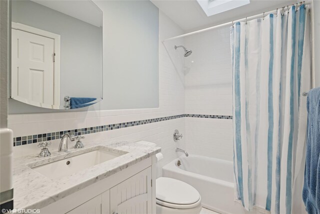 475 Lilac Ln, Cutchogue, NY 11935 - full bath with a skylight, vanity, shower / bathtub combination with curtain, tile walls, and tasteful backsplash