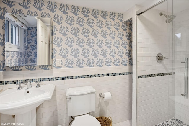 475 Lilac Ln, Cutchogue, NY 11935 - bathroom with wallpapered walls, a shower stall, and wainscoting